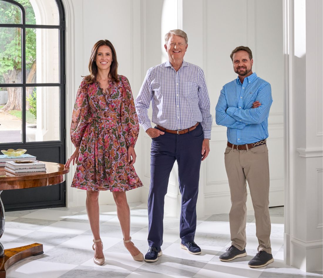 photo of John Hawkins, Kelly and James facing camera team happy in kitchen of hawkins-welwood luxury home