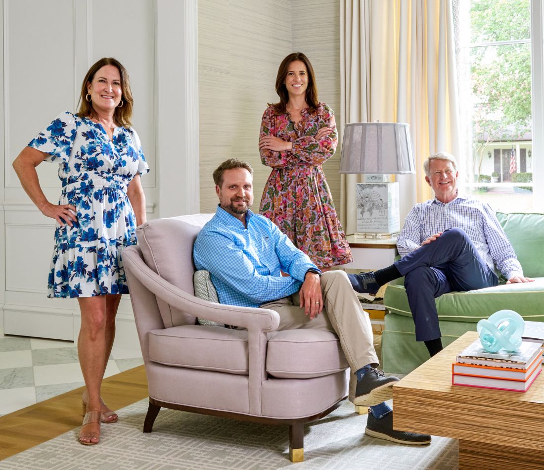 photo of John Hawkins, Kelly and James working and looking at floorplan or layout on kitchen counter team working in luxury home dallas texas